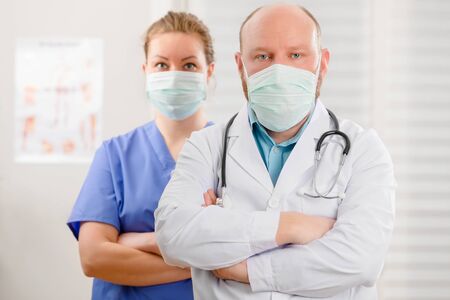 Confident and Exhausted Doctor And Nurse With Arms Crossed In Hostpitalの写真素材