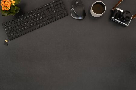 Overhead view of coffee and computer parts with camera on tableの写真素材