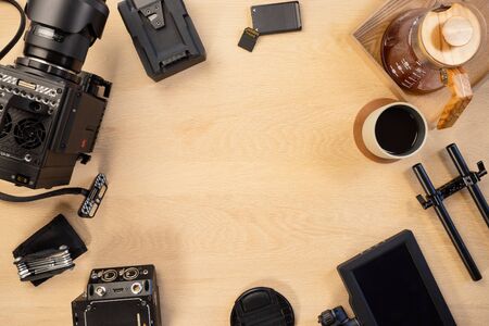 Directly above shot of filming equipment and coffee arranged on tableの写真素材