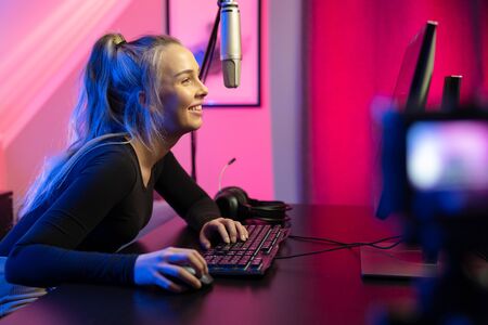 Professional esport gamer girl streaming vlog and plays online video game on PCの写真素材
