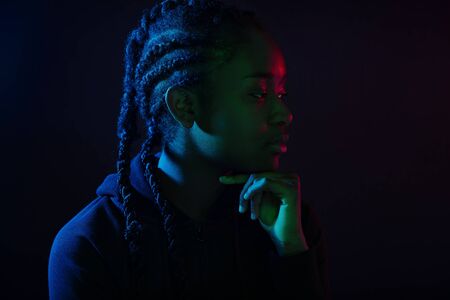 Colorful portrait of thoughtful cool woman with dark skin and braided hairの写真素材