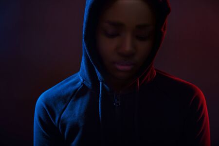 Colorful portrait of a cool woman with dark skin wearing hoodieの写真素材