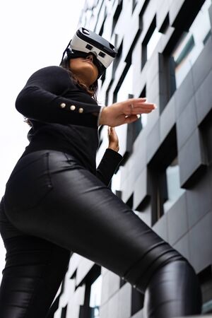 Focused Woman With VR Glasses In Futuristic and Urban Cityの写真素材