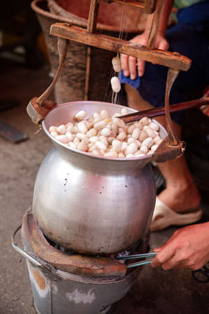 Man Boiling Silk Cocoons In Large Panの写真素材