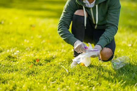 Low section of man cleaning park on sunny dayの写真素材
