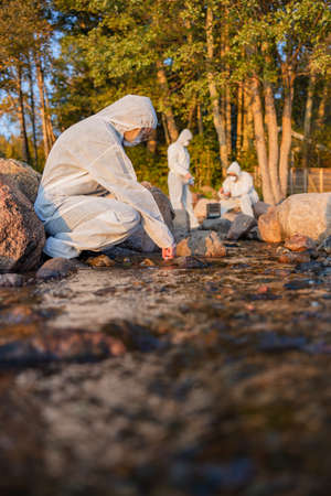 Female scientist collecting water sample from seaの写真素材