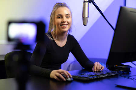 New Generation Female e-sport gamer streaming vlog online from officeの写真素材