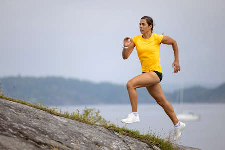 Athlete Sprinting On Mountain During Outdoor Workoutの写真素材
