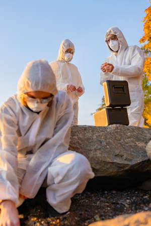 Team of scientist collecting water sample at seashoreの写真素材