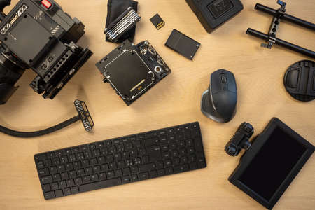 Flat lay of filming accessories with computer parts on tableの写真素材