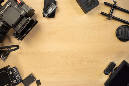 Directly above shot of video camera and accessories on tableの写真素材