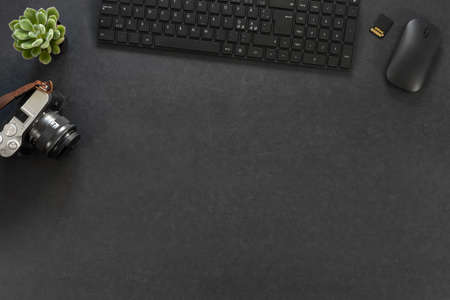 Directly above of computer parts with camera by green plant on tableの写真素材