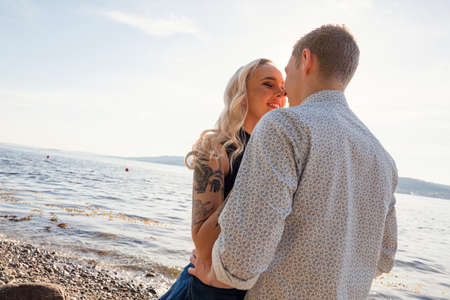 Beautiful young couple kissing on the beachの写真素材
