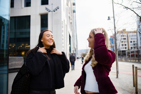 Two Female Friends Having Fun Laughing and Shopping in the Cityの写真素材