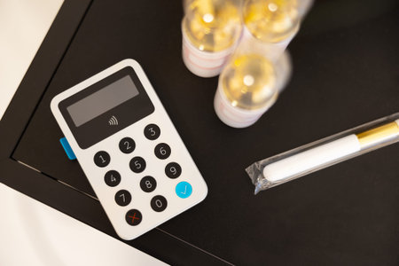 White Card Reader By Beauty Products On Table