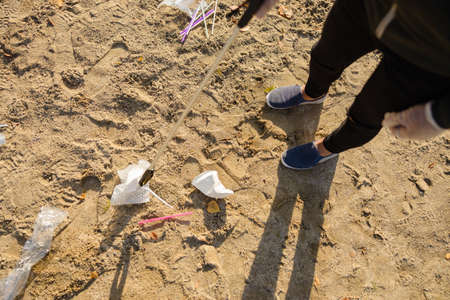 Top view of volunteer protecting environmental and picking up garbage at beachの写真素材