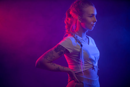 Colorful and close profile portrait of a confident blonde woman wearing white topの写真素材