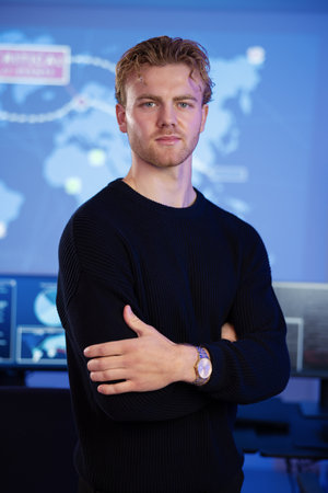 Male Cybersecurity Analyst in large Cyber Security Operation Center SOC handling Threatsの写真素材