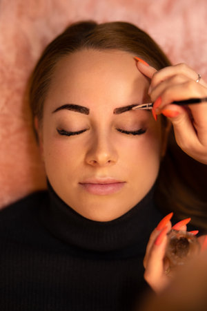 Beautician Applying Dye On Female Customers Eyebrowの写真素材