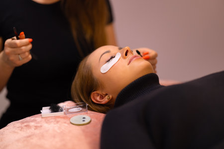 Woman Going Through Eyelash Extension Treatment At Beauty Clinicの写真素材