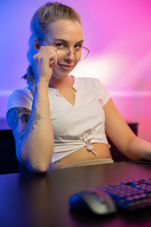 Professional gamer girl with headset play online multiplayer video game on PCの写真素材