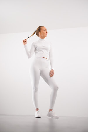 Sporty woman in athleisure against white backgroundの写真素材