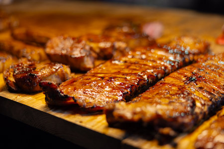 Grilled meat served on wooden boards, highlighting street food and culinary authenticityの写真素材