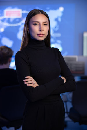 Serious Female Cybersecurity Analyst or Manager in large Cyber Security Operations Center SOC handling Threatsの写真素材