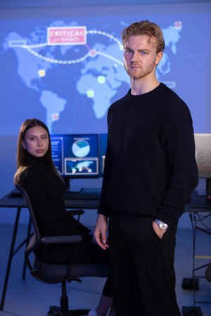 Male Cybersecurity Analyst and his team in Cyber Security Operation Center SOC handling Threats.の写真素材