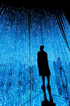 Woman and other people in illuminated virtual multiverse concept