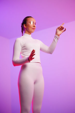 Woman in smartglasses gesturing against purple background