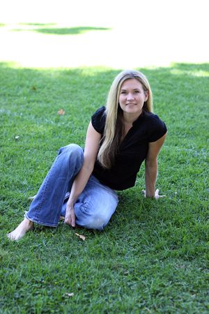 Blonde Woman sitting on the grassの写真素材