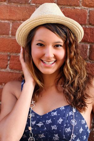 A pretty young, girl, wearing a hat.の写真素材