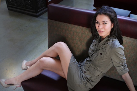 A pretty young woman relaxing indoors on a couchの写真素材