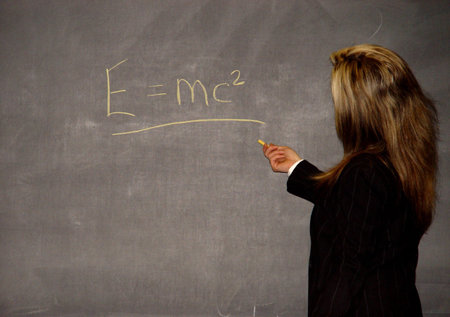 Female lecturer writing on blackboard