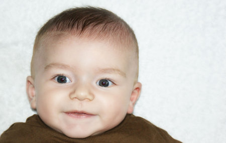 Close up photo of a smiling baby boy