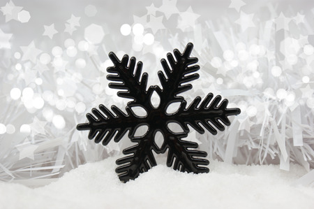 Christmas snowflake decoration nestled in snowの写真素材