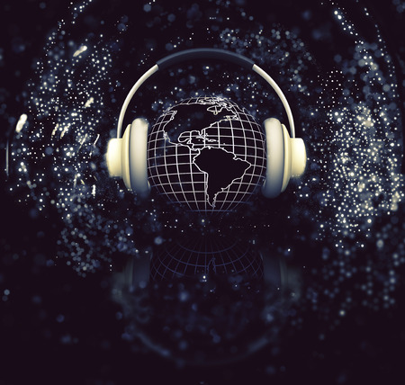 3D render of a globe with headphones on sparkle backgroundの写真素材
