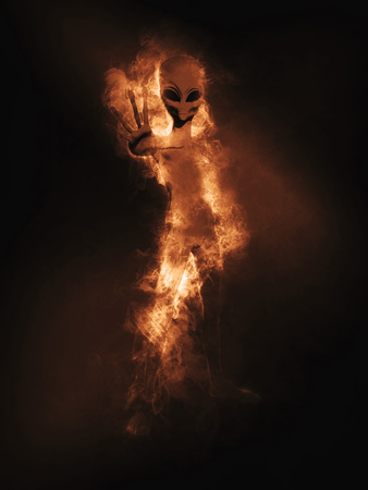 3D render of an alien figure appearing out of smoke and flamesの写真素材