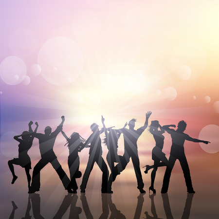 Silhouettes of people dancing on a summer sun backgroundの写真素材