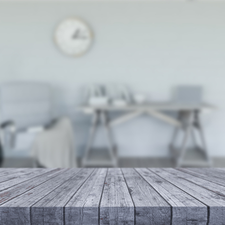 3D render of a white wooden table looking out to a defocussed room interiorの写真素材