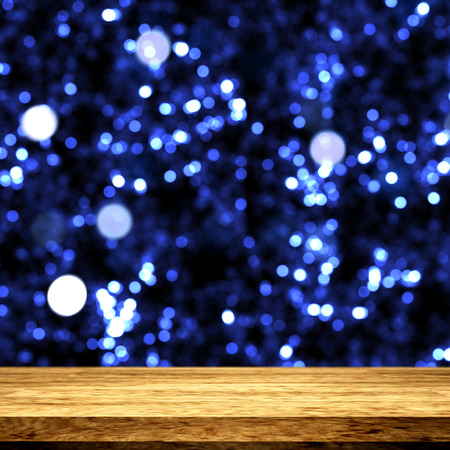 3D render of a wooden table looking out to a bokeh lights backgroundの写真素材