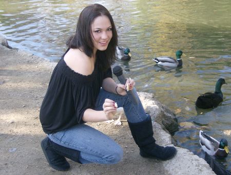 Pretty Singer feeding Ducks and Geeseの写真素材