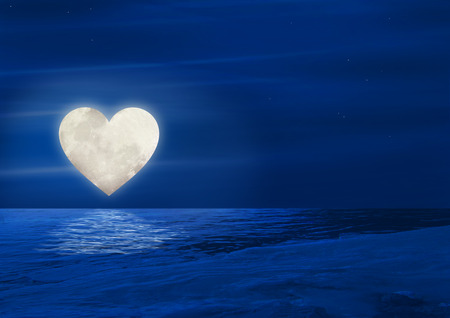 Heart moon reflecting over waterの写真素材