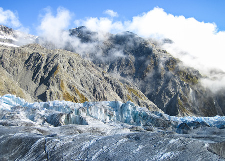 The Fox Glacier, covered in a fine layer of debris, as seen on a sunny day. South island of New Zealand.の写真素材