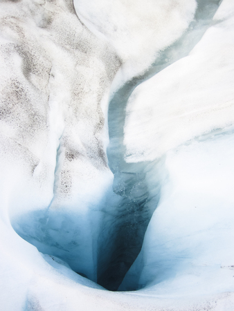 a hole which allows water to pass from the surface to the bottom of a glacier. Photographed on the Fox Glacier, south island of New Zealand.の写真素材