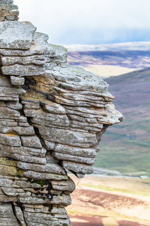Rock layers smoothed by years of weathering are seen near the summit of Pen-y-Ghent in the Peak District, England.の写真素材