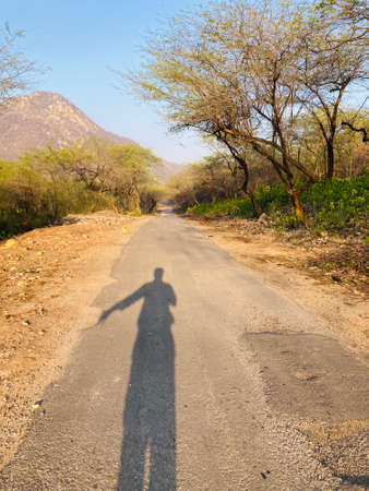 Shadow of a man on the roadの写真素材