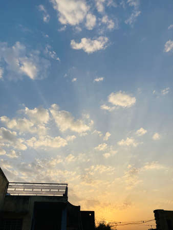 Sunset sky with clouds and sun rays. Beautiful nature background.の写真素材