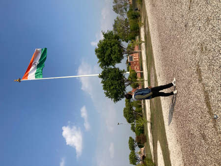 Aerial view of a man flying with a flag on a pole.の写真素材
